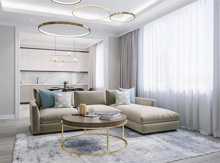 Una sala de estar moderna con cocina americana, diseñada en colores neutros. 